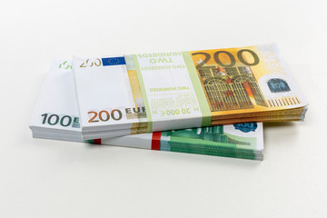 Euro cash in bundles of one hundred and two hundred banknotes, Euro money Euro on a white background, isolated on a white background