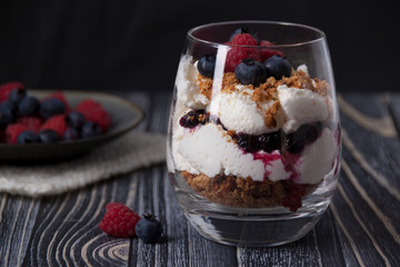 Curd dessert with raspberries, blueberries and cookies