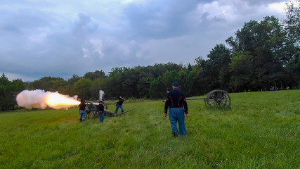 Civil War Reenactment Cannon Firing on a Sunny Summer Day as Seen by a Drone