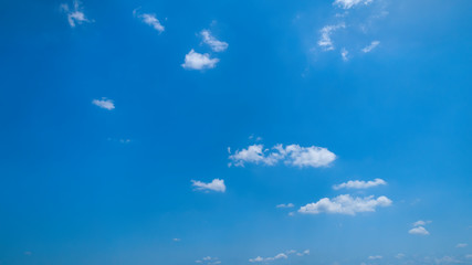 Fototapeta na wymiar White Clouds Floating in the Bright Blue Skies