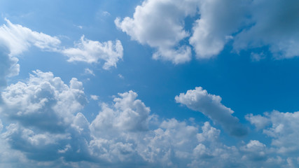Fototapeta na wymiar White Clouds Floating in the Bright Blue Skies