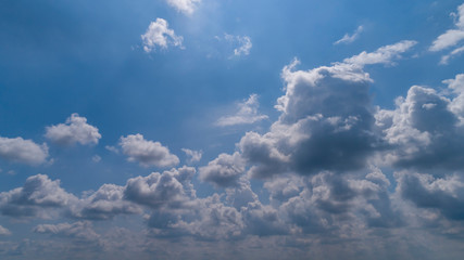 Fototapeta na wymiar White and Dark Clouds Floating in the Bright Blue Skies