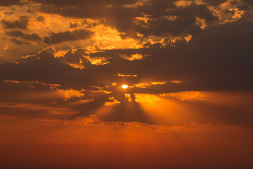 red dawn, the sun breaks through the clouds, rays of light, beautiful dawn