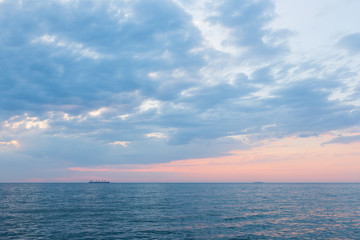 Fototapeta premium red dramatic morning on the sea coast, two ships on the horizon, big beautiful cloud
