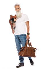 Handsome bearded senior man with leather bag and jacket on white background