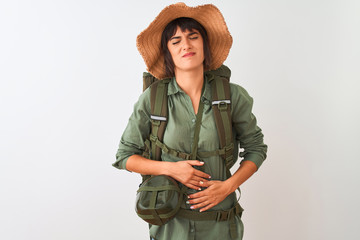 Hiker woman wearing backpack hat and water canteen over isolated white background with hand on...