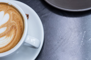 hot art coffee latte on wooden table.