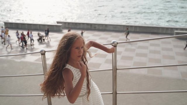 Child girl dancing in the city street
