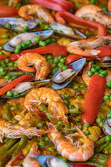 Spanish seafood paella in fry pan with mussels, shrimps and vegetables