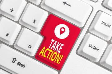 Writing note showing Take Action. Business concept for do something official or concerted to achieve aim with problem White pc keyboard with note paper above the white background