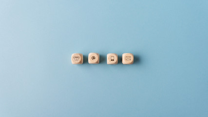 Contact and communication icons on wooden dices