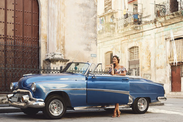 Beautiful woman driving a retro convertible car