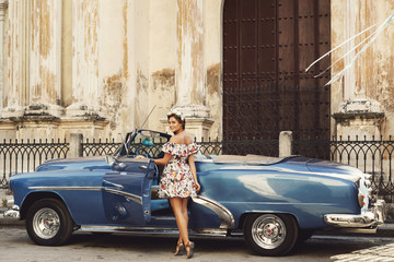 Woman wearing beautiful dress and retro convertible car