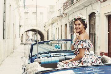 Woman wearing beautiful dress and retro convertible car