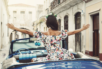 Woman wearing beautiful dress and retro convertible car