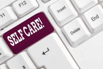 Writing note showing Self Care. Business concept for practice of taking action to preserve or improve ones own health White pc keyboard with note paper above the white background