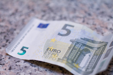 5 euro note on granit stone table