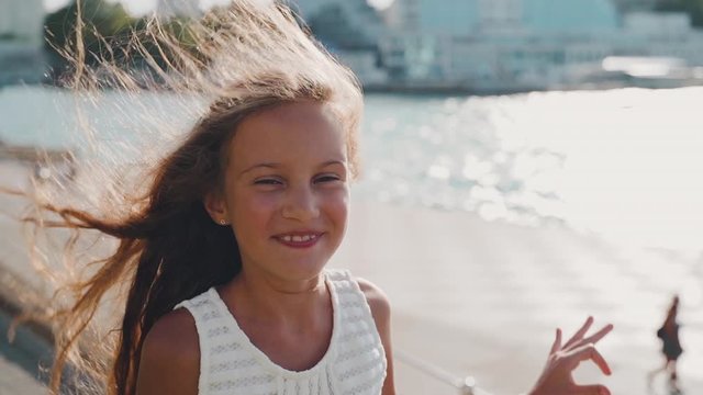 Kid girl smiling wide and looking at camera