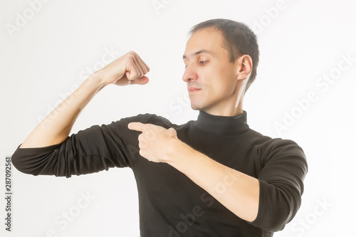 Portrait Of Young Handsome Dark Haired Man Holding His Arm Up To
