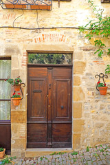 Fototapeta na wymiar Old solid wood door of a house of Cordes sur Ciel, old medieval village elected favorite village of french, in the Tarn department in the Occitan region