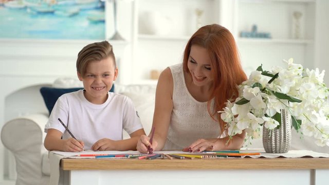 The child shares his idea with his mother during a time together Colored pencils
