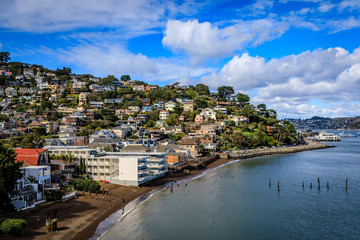 Idyllic view of the south end of Sausalito waterfront on a very clear sunny day with fluffy clouds and a few birds