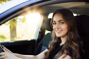 Attractive young girl driver in new car