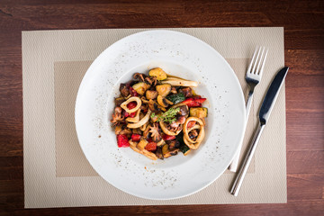 Salad Squid and Octopus Stewed with Vegetables at the table of restaurant