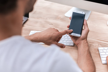 businessman uses his smartphone in the office