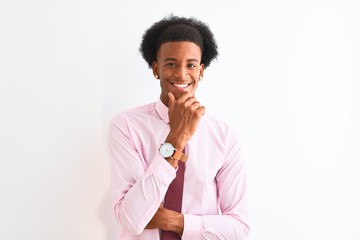Fototapeta na wymiar Young african american businessman wearing tie standing over isolated white background looking confident at the camera smiling with crossed arms and hand raised on chin. Thinking positive.