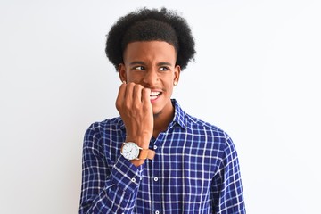 Young african american man wearing casual shirt standing over isolated white background looking stressed and nervous with hands on mouth biting nails. Anxiety problem.