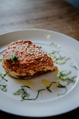 Raw vegan lasagna on a white plate. Dairy free, gluten free food.