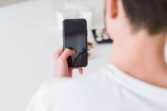Close upf man using smartphone to orden take away asian food from delivery
