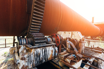 Old rusty rotating kiln in cement manufacturing plant - obrazy, fototapety, plakaty