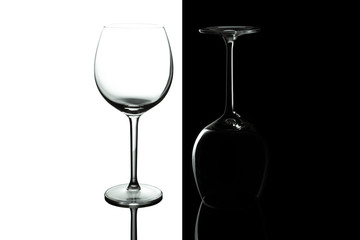 Empty wine glasses for wine isolated on black and white background. Wine list design menu with copy space. Alcohol beverage card backdrop.