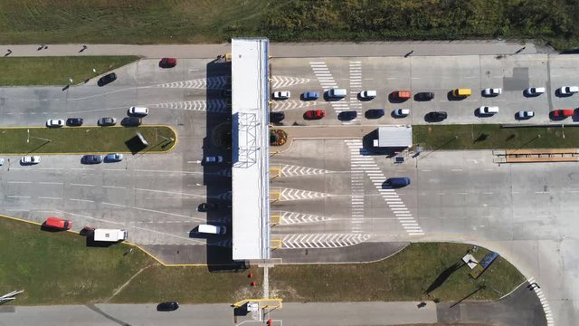 Checkpoint booth with entry fee payment to enter paid area of market or toll road. Car traffic jam. Vehicle queue at boundary.