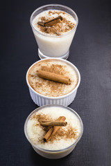 jars of rice pudding with cinnamon. Typical porridge from Brazil made with rice, condensed milk and coconut. Brazilian food typical of rural parties of June and July. Gastronomic tourism concept.