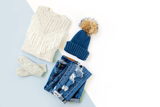 Blue Winter Hat With Jeans, Sweater And  Mittens On White Background. Women's Stylish Autumn Or Winter Clothes. Trendy Clothes Collage. Flat Lay, Top View.