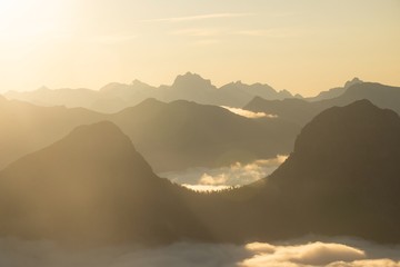 Mountain layers tower above morning fog 