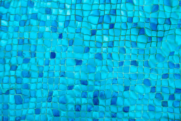 Swimming pool blue mosaic rock bottom. Texture.