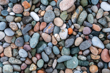 Close up of rounded and polished beach rocks.