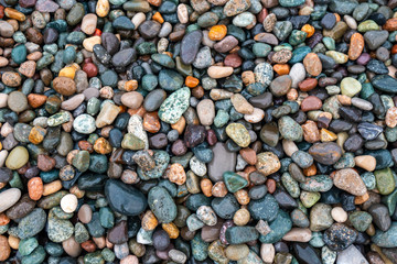 Close up of rounded and polished beach rocks.