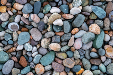 Close up of rounded and polished beach rocks.