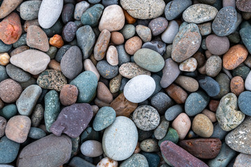 Close up of rounded and polished beach rocks.