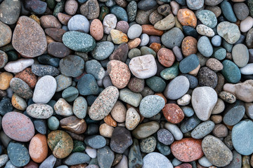 Close up of rounded and polished beach rocks.