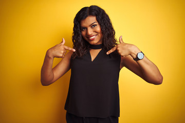 Transsexual transgender elegant businesswoman standing over isolated yellow background looking...