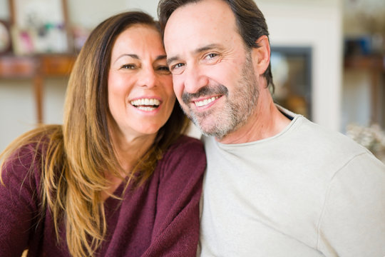 Beautiful romantic couple sitting together on the floor at home