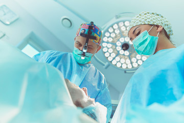 Man surgeon at work in operating room