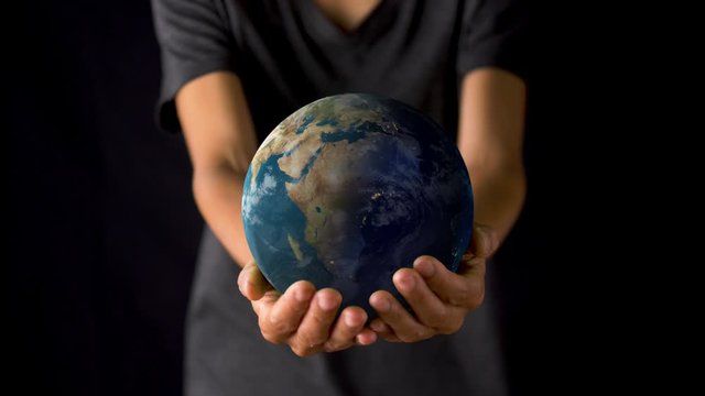 Female hand holding a realistic Earth. Holding the world in your hand. Rotation planet. Earth globe. World map design. Global sphere planet. Texture map courtesy of NASA.