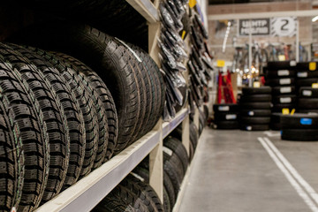 Obraz na płótnie Canvas Car tires and wheels at warehouse in tire store.